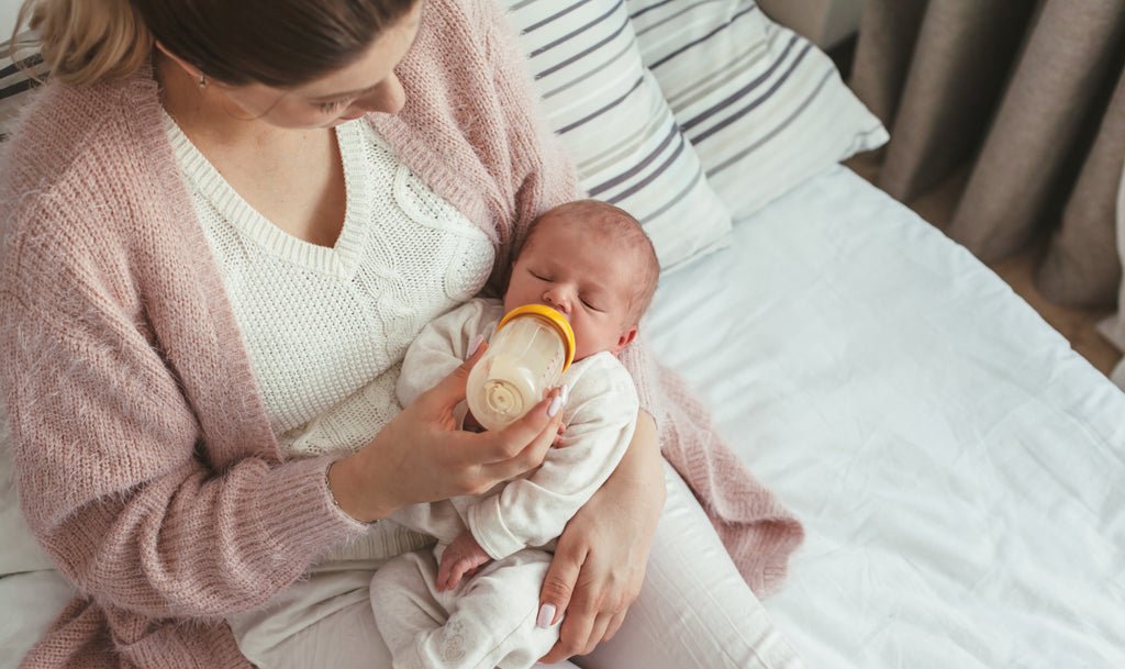 Mother feeding a child with organic formula